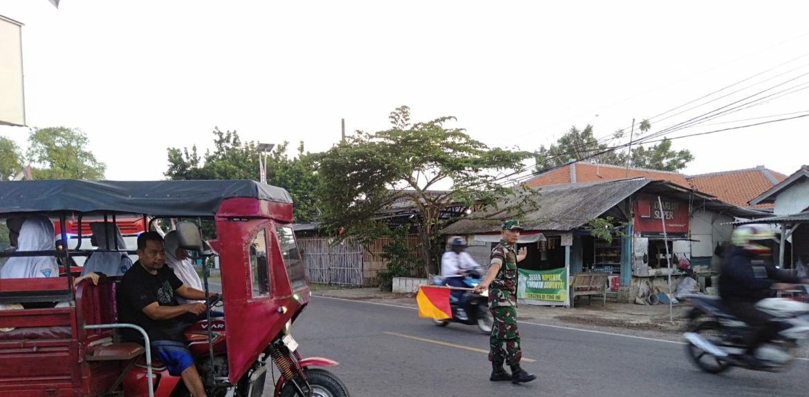 Cegah Lakalantas, Babinsa Koramil 1609 Juntinyuat Indramayu Bantu Masyarakat dan Anak Sekolah Menyebrang Jalan Raya 